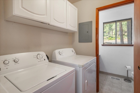 laundry room located next to 1/2 bath on same level as kitchen /dining and huge back deck over creek
