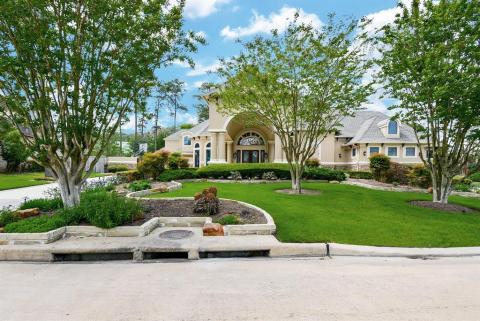 View of the front of the house. Beautiful landscaping throughout the property