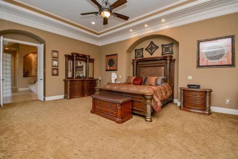 The primary bedroom is spacious and has amazing trayed ceiling and a sitting area