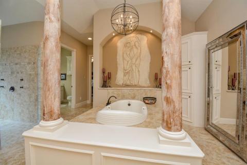 Big bathtub with a beautiful light fixture above