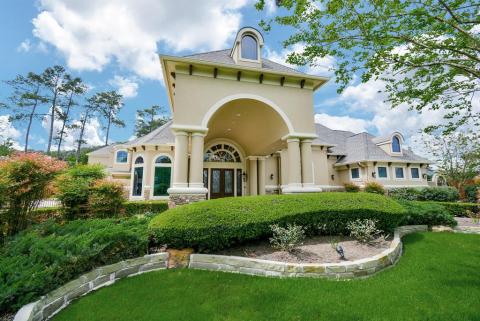 Both sides of the driveway lead to this grand porte-cochere.