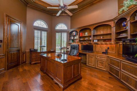 Elegant study with beautiful wood built ins.