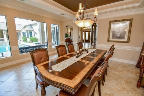 Formal dining has lots of room to entertain and fantastic views of the outside oasis.