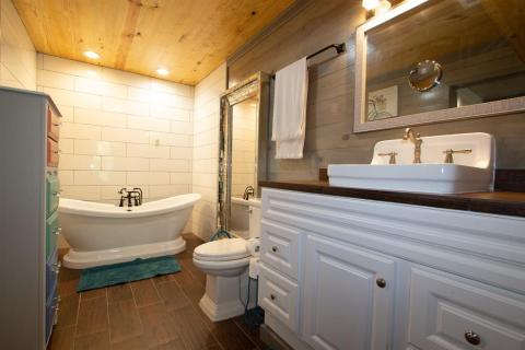 One of two master baths with gorgeous tiled flooring and able to maintain the original sink adorned by custom cabinetry and credenza for sundries...What a PRIVATE RETREAT!