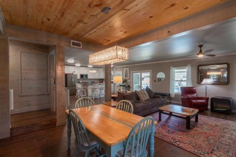 Desired extensive Open Living leading to the covered patio and screened-in porch and windows for natural lighting