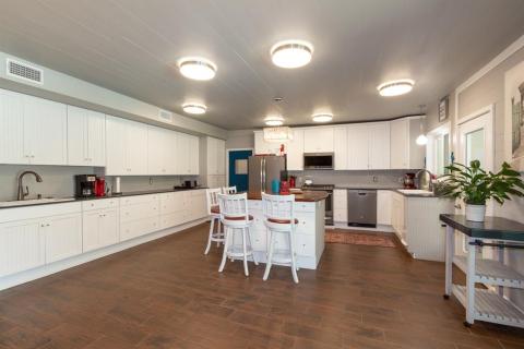 Huge KITCHEN with one-of-a-kind mesquite-topped island, wood cabinetry accented with beadboard, silestone counters and includes all appliances.
