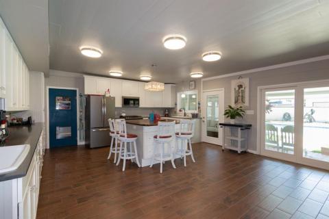 Another view of the Kitchen leading to the screened-in Porch and Covered Patio