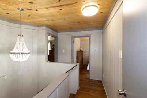 Upstairs landing which leads to all three bedrooms...notice the original hardwood floors.