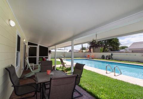 View from the covered patio to the screened in porch leading to the guest restroom. Nice!! From this angle of the pool, you just want to JUMP IN!