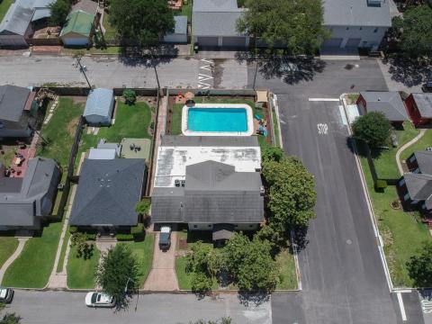 Aerial view of your new spacious home and relaxing saltwater pool. Do not miss this rare opportunity of Island Living.