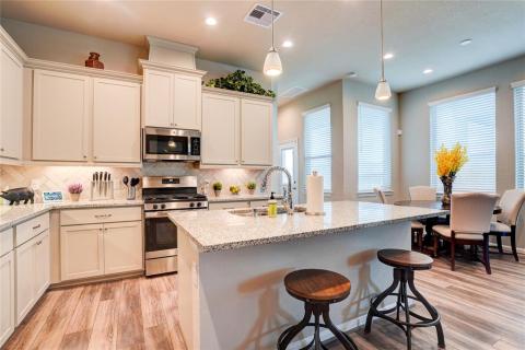 Notice the built-in breakfast bar running along the large kitchen island.