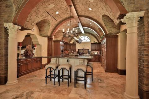 Wow describes this outstanding kitchen. Ready for the chef in the family! Large decorative columns, brick barrel ceiling with wood accents, breakfast bar, & huge island are featured in this expansive kitchen! two kitchens in this amazing house, main and catering. Wow describes this outstanding kitchen. Ready for the chef in the family! Large decorative columns, brick barrel ceiling with wood accents, breakfast bar, & huge island are featured in this expansive kitchen! two kitchens in this amazing house, main and catering.