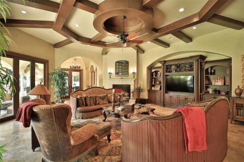 Splendid Family room with custom entertainment center, circular wood beam ceiling, 8 Canopying glass doors that can open up the entire family room to the patio area, fireplace, & large wet bar off the family room for entertaining your guests! Splendid Family room with custom entertainment center, circular wood beam ceiling, 8 Canopying glass doors that can open up the entire family room to the patio area, fireplace, & large wet bar off the family room for entertaining your guests!