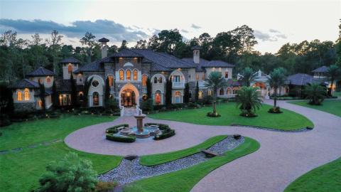 A sunset view of the front of this Showcase home! Paved circular driveway to the entrance as well to the back where the garage is located! Large decorative outdoor fountain for incredible ambience! A sunset view of the front of this Showcase home! Paved circular driveway to the entrance as well to the back where the garage is located! Large decorative outdoor fountain for incredible ambience!