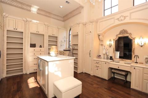 Oh my! This is only half of the Ladies closet! Loaded with custom built-ins & shelves, astonishing crown molding, wood floors, chandelier lighting, windows to give great natural light, & a showcase vanity area. Not shown a 3 angled mirror in your dressing room to make sure your attire is just right! Oh my! This is only half of the Ladies closet! Loaded with custom built-ins & shelves, astonishing crown molding, wood floors, chandelier lighting, windows to give great natural light, & a showcase vanity area. Not shown a 3 angled mirror in your dressing room to make sure your attire is just right!