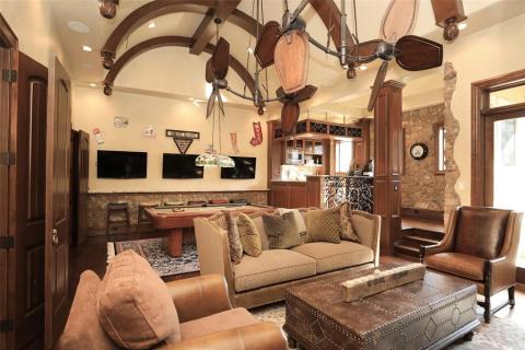 Generously sized (only half pictured) Adult game room & pub with 4 TV's for the ultimate entertaining! Outstanding barrel beamed ceiling & unique fans, brick accent walls, and private balcony that overlooks the meticulously manicured grounds! Don't want to take the stairs up, no problem, the elevator is waiting for you! Generously sized (only half pictured) Adult game room & pub with 4 TV's for the ultimate entertaining! Outstanding barrel beamed ceiling & unique fans, brick accent walls, and private balcony that overlooks the meticulously manicured grounds! Don't want to take the stairs up, no problem, the elevator is waiting for you!