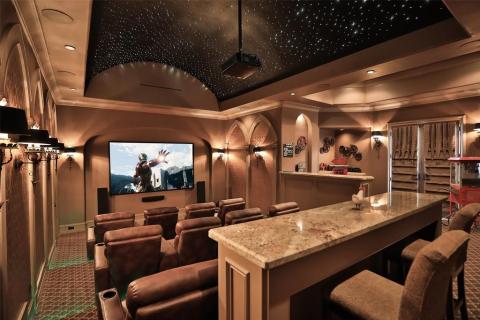 This Theater room offers State of the Art Design! Bar seating to munch on snacks while at the movies! Fabulous sconce lighting, foot lighting to see when the lights are out, and barrel ceiling of lights to enhance your movie experience! Doors lead to the private balcony! This Theater room offers State of the Art Design! Bar seating to munch on snacks while at the movies! Fabulous sconce lighting, foot lighting to see when the lights are out, and barrel ceiling of lights to enhance your movie experience! Doors lead to the private balcony!