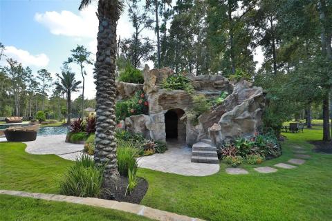 A closer view of the professionally landscaped cave of the main pool. Climb the stairs & slide down to the pool or enjoy the fire pit area that is above the cave with your guests. The views from this area are remarkable. No need to leave your back yard with this tropical oasis! A closer view of the professionally landscaped cave of the main pool. Climb the stairs & slide down to the pool or enjoy the fire pit area that is above the cave with your guests. The views from this area are remarkable. No need to leave your back yard with this tropical oasis!