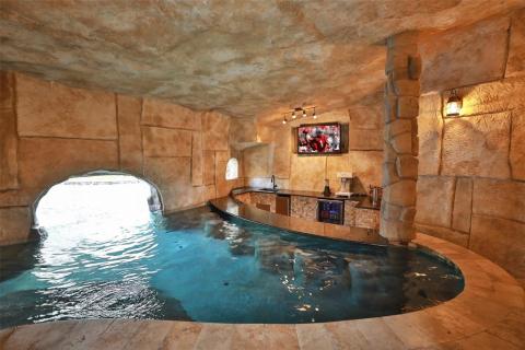 Swim up to or walk into this breathtaking cave! Watch your favorite sport or TV show while sipping on your preferred drink! Bar seating, mini refrigerator, ice maker, kegerator, what more could you need or even want! Entertaining is made very easy here! Swim up to or walk into this breathtaking cave! Watch your favorite sport or TV show while sipping on your preferred drink! Bar seating, mini refrigerator, ice maker, kegerator, what more could you need or even want! Entertaining is made very easy here!