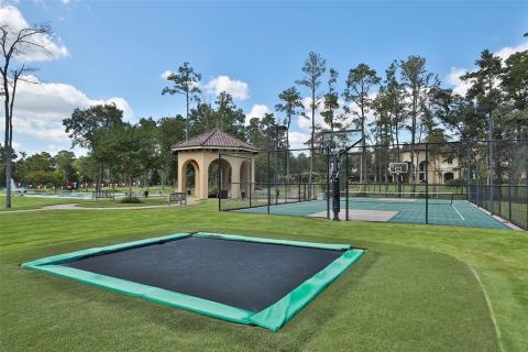 Such an entertaining back yard for all ages! This in-ground trampoline will sure be a kid pleaser and many hours of fun will be played here! Also a private sports court that is complete with a basketball court and/or a tennis court! Simply amazing! Such an entertaining back yard for all ages! This in-ground trampoline will sure be a kid pleaser and many hours of fun will be played here! Also a private sports court that is complete with a basketball court and/or a tennis court! Simply amazing!