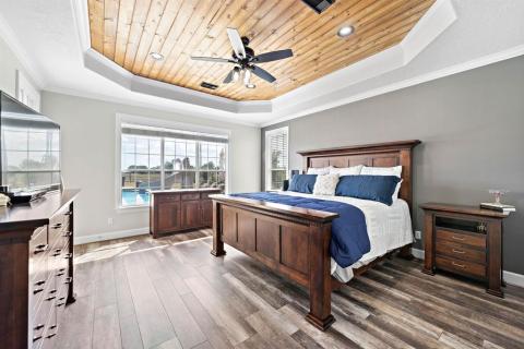 WOW, is all you can say as look at this Exquisite and Enormous Primary bedroom with multiple views to the outdoor retreat. The tray ceiling with the stained tongue and groove pine gives this room an added feeling of warmth.