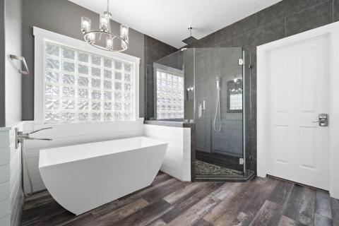 Freestanding Tub and extensive walk in Shower with rain head shower, bench seating, and built in Nitches!