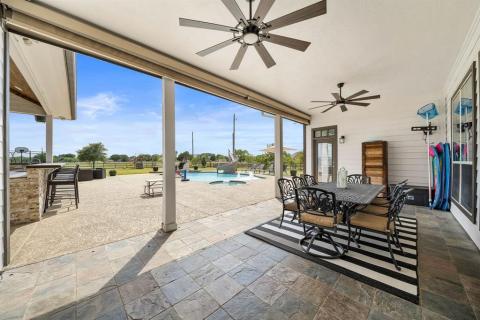 Oversized Covered Back patio with dual ceiling fans,Mounted TV area, Gigantic amount of Yard, A Covered Outdoor Kitchen, Fire Pit with Seating, and A Magnificent Pool with a slide to top things off!!