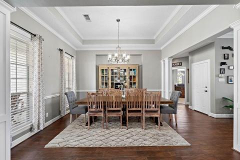 As you enter the home the formal dining room is to the left.  Substantial size of this room is demonstrate by how much room there still is even with a Table for Ten!