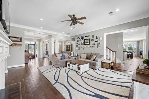 A different view of the Living room which provides views of the Entry way, Dining room, the stairs area, and one of the ways into the kitchen.