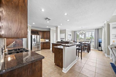 One of the ways to enter this Stunning kitchen that is made for cooking, and all the entertaining you can handle with all the counter top space,  Lots of cabinets, and walk in pantry.