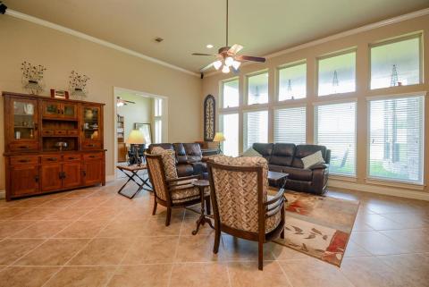 This is where simple, easy living happens in a grand setting. A wall of floor-to-ceiling windows line this versatile living area, with room for sizeable accents.