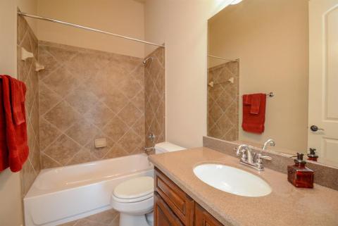 This secondary bath is bright, crisp and inviting, with combined shower/bathtub for easy access.