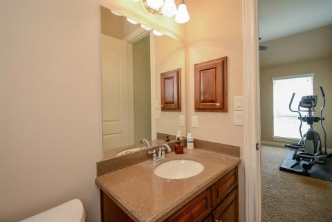 A convenient half-bath is appreciated in this ensuite room.