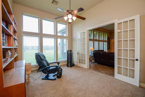 How divine! Another set of delicate french doors open from the living area onto another, lush flex space.