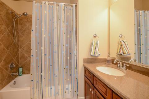Rich appointments make this shared bath comfortable and as serviceable as its primary counterpart.