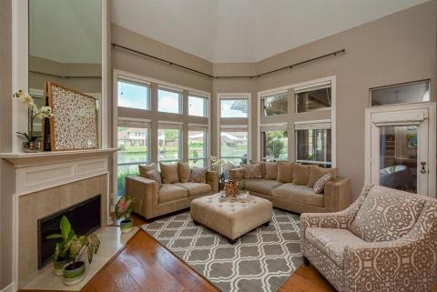 Warm, mocha tones grace walls and accented surfaces in this sublime casual living/family area, frosting this award-winning "cake" with memorable icing! This cozy, relaxing curved wall of windows embraces your favorite sizeable treasures, while overlooking a carpet of green and tranquil waters, outside.