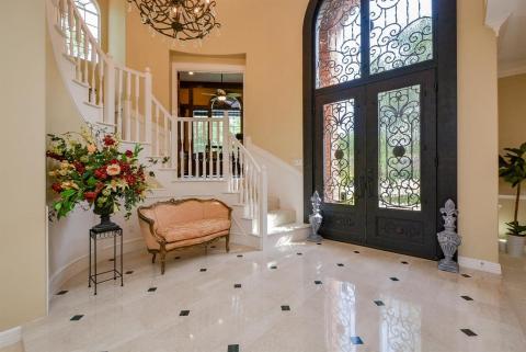 This one-of-a-kind residence has to be seen to be enjoyed and believed! Glistening custom tile floors play canvas to warm, earth toned walls and accent choices. The modest introduction of the exquisite spiral staircase off the regal rotunda, is just a tease, as to the absolutely amazing features that consitute this home,  eagerly waiting for your view. (Yes. The traditonal home office/study is uniquely situated off a stairway landing!)