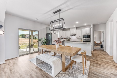 Dining room featuring light wood-type flooring and a notable chandelier