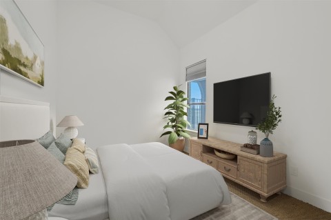 Carpeted bedroom with lofted ceiling