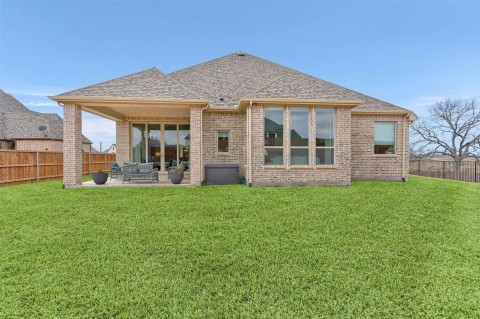 Back of house featuring a yard and a patio area