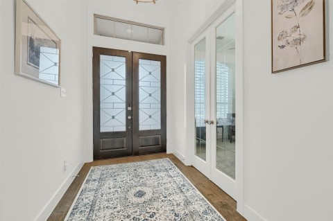 Foyer featuring french doors and dark hardwood / wood-style floors