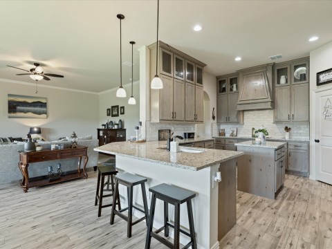 Kitchen featuring a peninsula, light wood-style flooring view of living room
