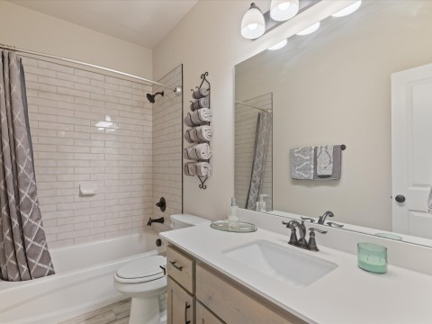 Full bathroom with wood finished floors, single vanity