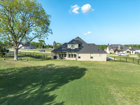 Rear view of house with a fenced backyard