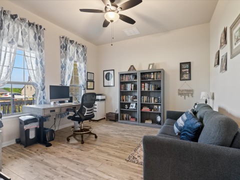 Office area featuring a ceiling fan, and wood finished floors