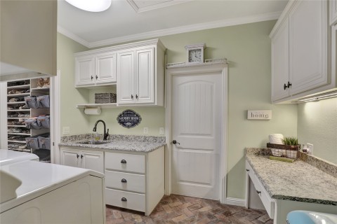 Huge walk in closet off of primary bathroom and leads into laundry room