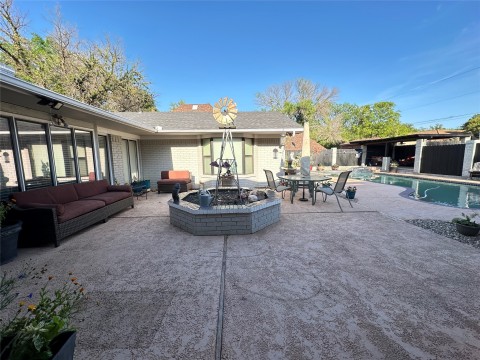 View of patio featuring an outdoor hangout area and a fenced in pool