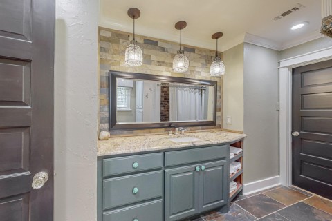 Jack and Jill bathroom with custom granite counter tops pull out drawers