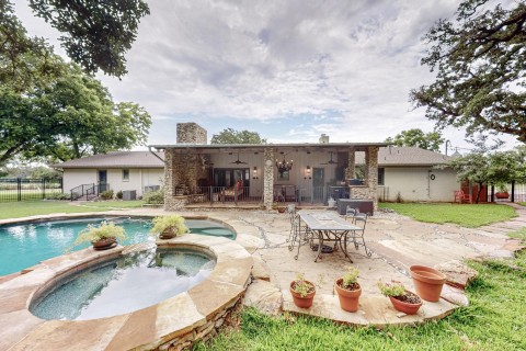 View of pool with a patio, an in ground hot tub, lawn and landscaping