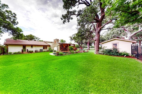 Wide view of backyard note separate building for pool supplies